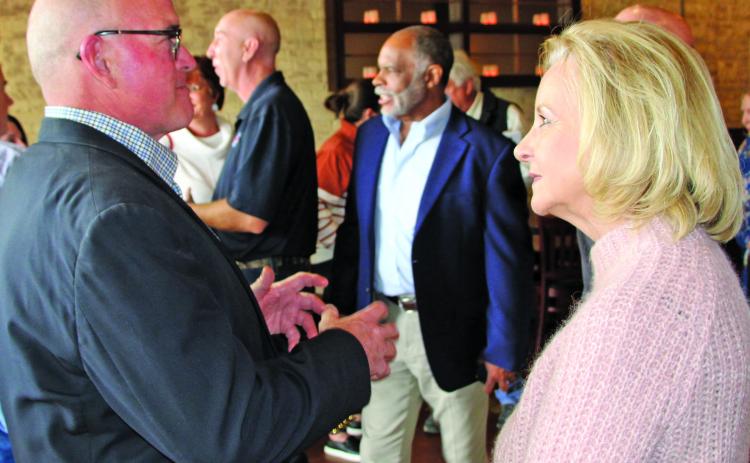 Sentinel photo/Mike Reddell John Runnels III explains a point with State Rep. Geanie Morrison at a reception for her Feb. 15.