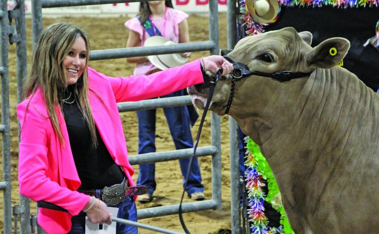 Sentinel photo/MaLinda Reddell Van Vleck FFA member Kenzie Brown is all smiles as she shows the Grand Champion steer at the 2022 Matagorda County Fair & Livestock Association (MCFLA) Junior Livestock Auction she sold for $11,000 Saturday, March 5.