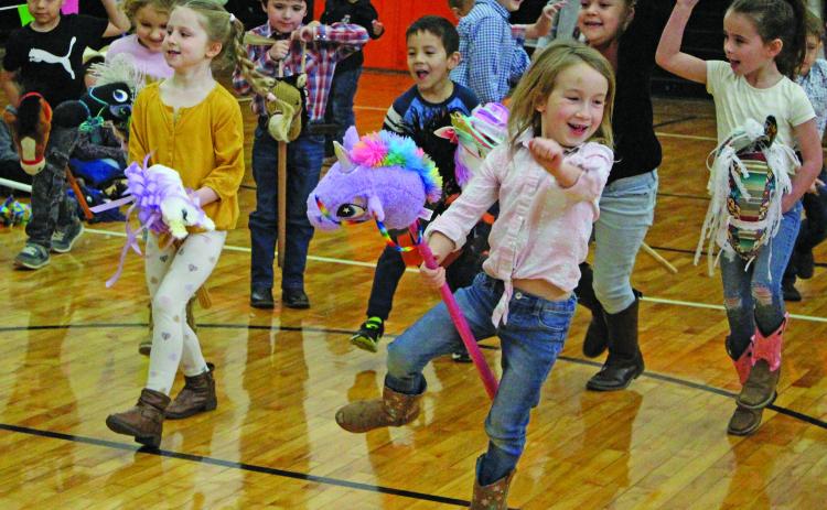 Sentinel photo/Jessica Shepard Van Vleck Elementary kindergarten students showed off their stick-horse bronco riding skills during the campus' "Kindergarten Rodeo" Friday, March 11. Other rodeo events included barrel racing and riding steers.