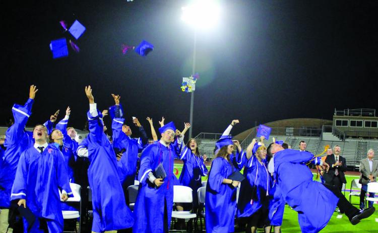 Sentinel photo/Jessica Shepard Tidehaven High School seniors launch their caps at the conclusion of commencement ceremonies at Delvin Taska Stadium, Friday, May 20.