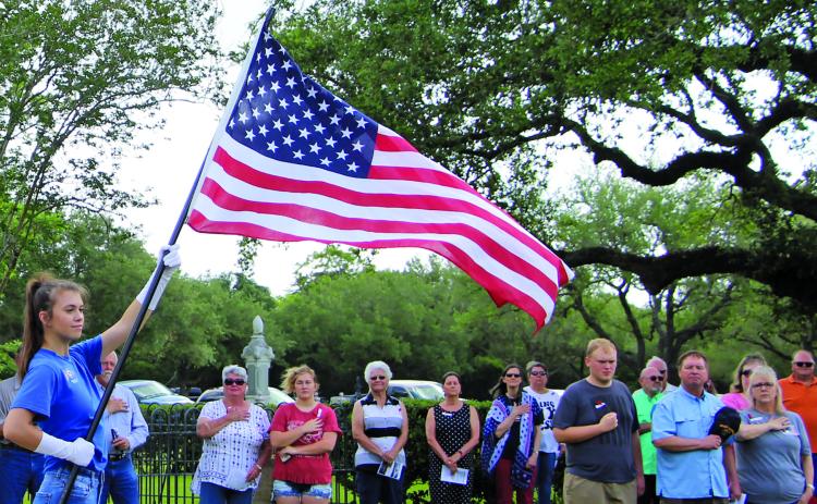 Sentinel photo/Mike Reddell A flag presentation by the Junior Girls Auxiliary for Memorial Day services at Hawley Cemetery including U.S. and Armed Services flags.