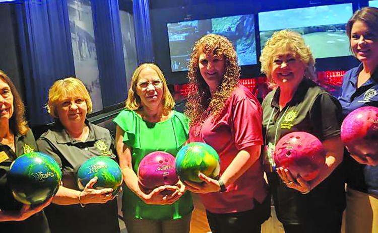 Sentinel photo/Jessica Shepard Members of the Pilot Club of Bay City recently donated lightweight bowling balls to Schulman’s Movie, Bowl & Grille. The multi-colored balls have been drilled with holes for small fingers to help younger children being able to enjoy this sport at Schulman’s. Pilot Club members from left to right are Jennifer Bishop, Theresa Knebel, Loretta Griffin, Schulman's MBG Event Director Crystal Folse, Sue Jahnsen, and Kristi Lee.