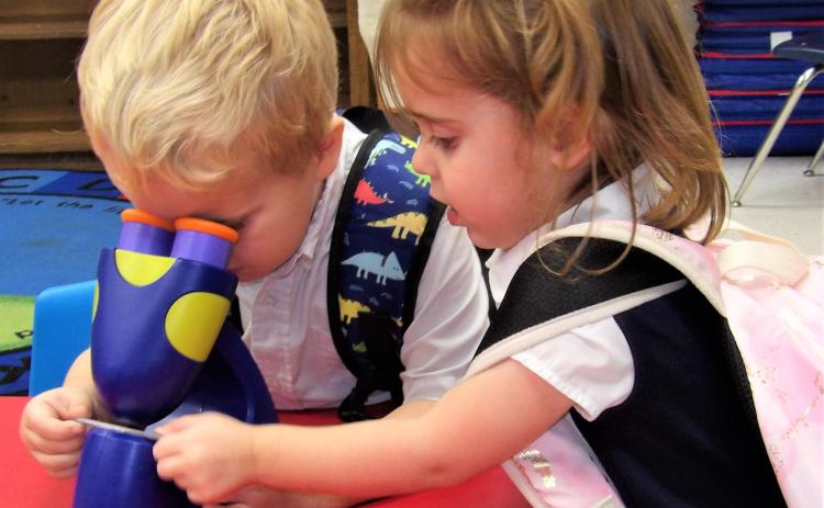 Courtesy photo Holy Cross Catholic School had its open house on Aug. 25. PreK-3 students with their microscopes provided a look at inquisitive young ones.