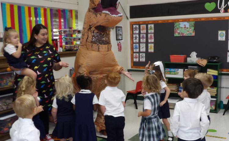 Courtesy photo Holy Cross Catholic School Pre-K 3 students had a dinosaur visit Ms. Lacy’s class. Mrs. Russell - one of the school’s parents - wore her awesome dinosaur costume to teach the students about the letter "D." Most of the students were ecstatic and Mrs. Escobar actually pulled the dinosaur’s tail.