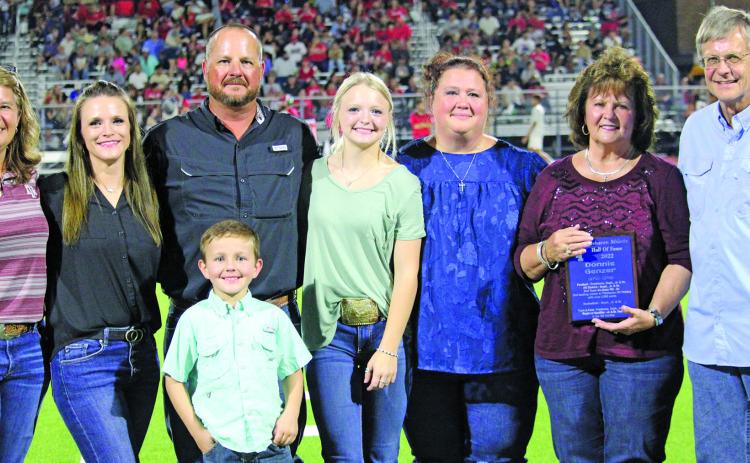 Sentinel Photo/Jessica Shepard Tidehaven Athletic Booster Club inducted Diana Fisher into the Hall of Fame during halftime Friday, Sept. 9. Family members were on hand to receive the plaque in Fisher's stead. Fisher's sporting accomplishments included volleyball, basketball, and track and field. Fisher was also the first female athlete from Tidehaven to qualify at the state track meet throughout her high school career. She also achieved All District in basketball in her sophomore, junior, and senior years.