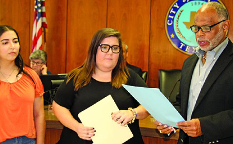 Sentinel Photo/Mike Reddell Crisis Center of Matagorda and Wharton County representives Desiree Viesca (left), Outreach Advocate, and Samanth Counts, Outreach Manager, listen as Mayor Robert Nelson reads the city’s proclamation declaring October as Domestic Violence Awareness Month.