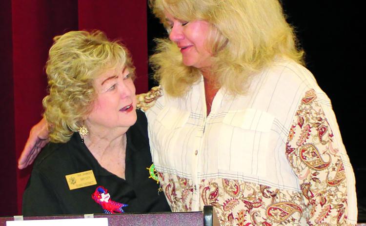 Sentinel Photo/MaLinda Reddell Pilot Club of Bay City President Sue Jahnsen hands off a memorial award to Sharyl McDonald in her mother Jeanette Opella's stead. The award recognizes Opella for her over 40 years of Pilot Club dedication and was featured at the Pilot International and district conventions earlier this year.