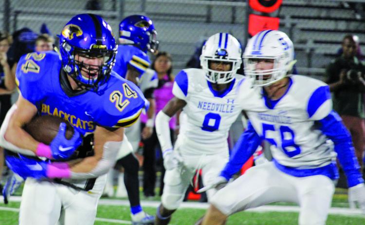 Sentinel Photo/Mike Reddell Senior Bay City running back Ayden Smith (24) takes the ball around end for yardage.