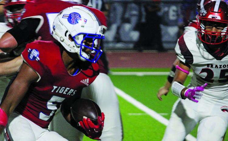 Sentinel Photo/Mike Reddell Tiger junior running back Joseph Dodds (5) looks for yardage  - en route to a 163-yard rushing game against Brazos last Friday.