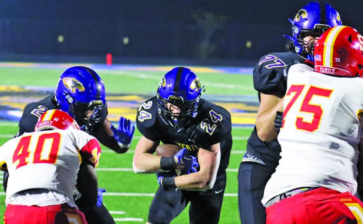 Live in the Moment/Le'Darion Stone Bay City blockers clear a path at the end zone for one of three touchdowns senior Ayden Smith (24) scored Friday night against Stafford.