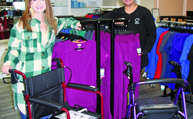 Sentinel Photo/Mike Reddell Help Inc. Business Development Manager Renee Laslie, left, and a fellow Help Inc. employee show off just some of the medical supplies available at the business during Christmas Around the Square, Nov. 17. Help Inc. also offers in-home care services and scrubs.
