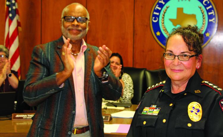 Sentinel Photo/Mike Reddell New Police Chief Christella Rodriguez stands amid loud applause led by Mayor Robert Nelson before a packed City Council Chamber after he administered her oath of office at council’s meeting Dec. 6.
