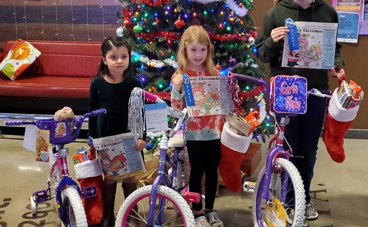 Sentinel Photo/MaLinda Reddell This year's Sentinel Christmas Coloring Contest winners are, from left, Denisse Palomares, Ruby Bonnot, and Ellasyn Milliff. Each girl received a bicycle, a blue ribbon for their artistry, and a Christmas stocking full of candy and other treats.