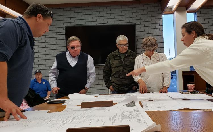 Sentinel Photo/Jessica Shepard Planning Commission board members review large-scale plans for subdivision plats before approving them Dec. 15.