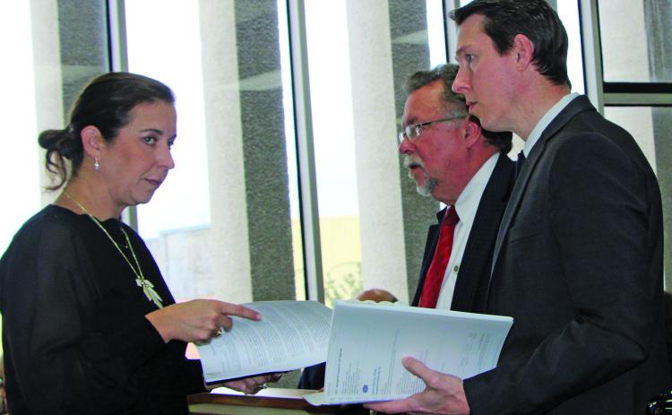 Sentinel Photo/Mike Reddell During discussions on the PCC Chemicals tax abatement request, BCCDC Executive Director Jessica Russell confers with MCEDC Executive Director Mike Ferdinand (center) and Tony Schum, Kroll director of site selection and incentives. There was a pause when County Attorney Jennifer Chau, via phone, noted the need to change a definition in the contract with PCC.