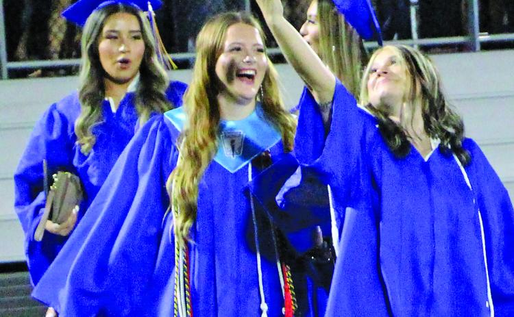 Sentinel Photo/Jessica Shepard Several Bay City High School graduates took time to snap a few selfies with their friends before throwing their mortarboard caps.
