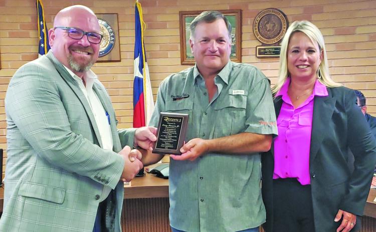 Sentinel Photo/Jessica Shepard Van Vleck ISD school board President Tony Kucera, center, was recognized for his 15 years of service to the district Monday night. The award was presented on behalf of the Region 3 Education Service Center with R3 ESC Execurive Director Morris Lyon and VVISD Superintendent Christie Dement thanking Kucera as well.