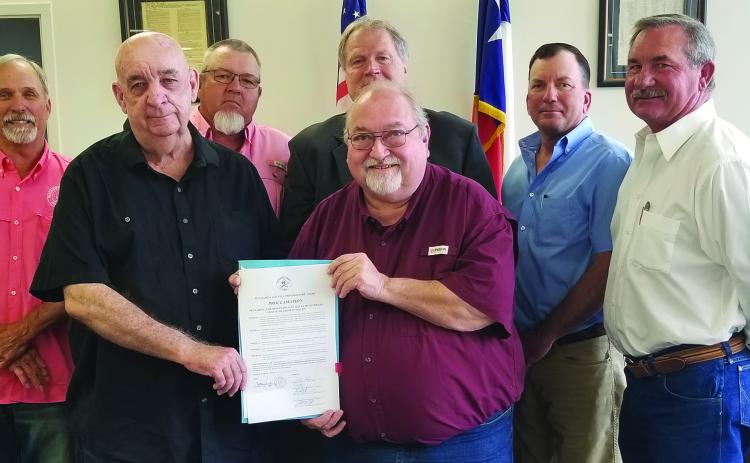 Sentinel Photo/Mike Reddell Commissioners Court approved a proclamation Monday declaring June as Myasthenia Gravis Awareness Month. In front are Edward Gillett from Palacios and Simon DeSoto of Bay City, both of whom have the disease. Back of them are, from left: Commissioners Bubba Cook and Bubba Frick; County Judge Bobby Seiferman; and Commissioner Troy Shimek.