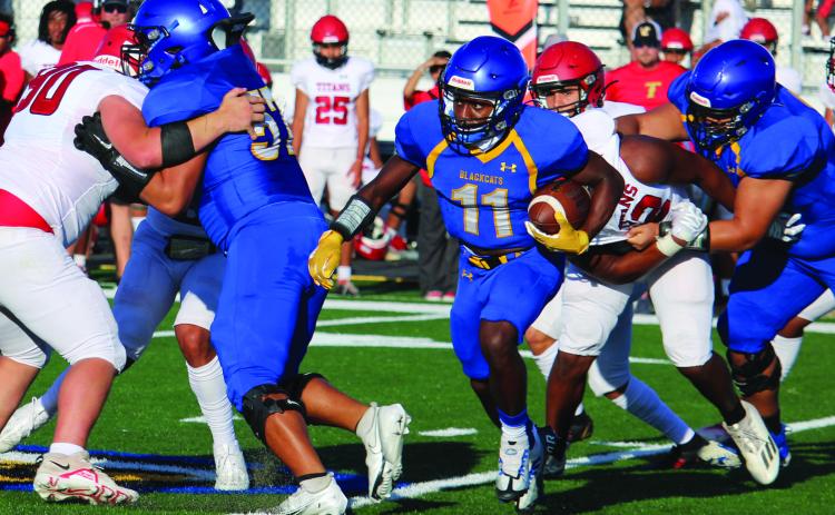 Sentinel Photo/Mike Reddell Above, junior Blackcat running back Jada Andrews (11) follows his blockers in last week’s scrimmage with Victoria East. Bay City will play Sweeny here this Friday.