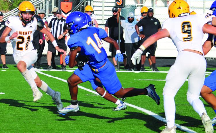 Sentinel Photo/Mike Reddell Above, senior Blackcat running back Paris Fox (14) picks up yardage against Liberty in the scrimmage here Friday, Aug. 11.