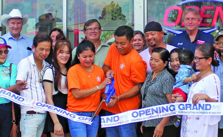 Sentinel Photo/Jessica Shepard Master Glazed Donuts partnered with the Bay City Chamber of Commerce & Agriculture to celebrate its grand opening with a ribbon-cutting ceremony Wednesday, Sept. 6 at the shop. The donut shop is located at 4206 7th St. in Bay City.