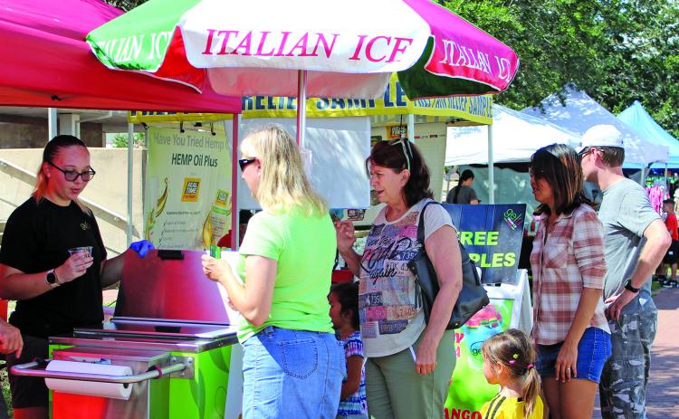While Saturday was officially the first day of fall, it didn’t feel like autumn with temperatures in the mid to high 90s. These folks at Saturday’s Market Day lined up for something cool. Sentinel Photo Jessica Shepard