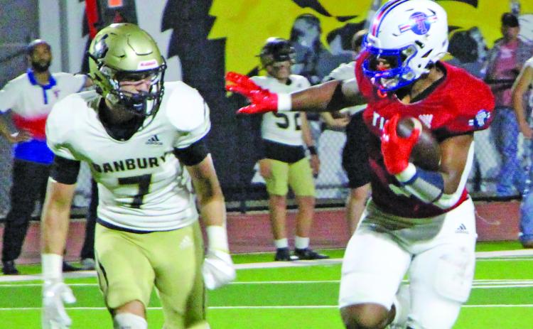 Sentinel Photo/Jessica Shepard Above, Tidehaven running back Joseph Dodds (5) prepares to stiff arm a Danbury defender.