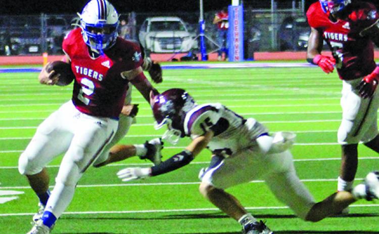 Sentinel Photo/Jessica Shepard Tidehaven running back Jachen Duran (2) stiff arms an East Bernard defender at last Friday contest at home.