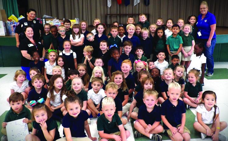 Contributed photo Ginger Iovanna and Lillie Norris with the Bay City Municipal Court visited Holy Cross Catholic School recently, along with Bay City Police Officer Tomasiato. The three ladies taught HCCS students about stranger danger, seatbelt safety, car seat safety, bike safety, and how not to ride in a vehicle when someone is under the influence.