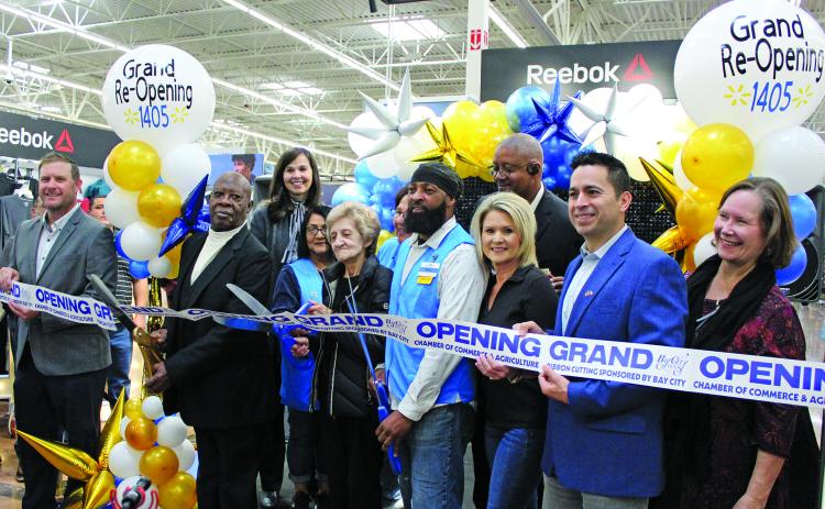 Sentinel Photo/Jessica Shepard Bay City Walmart partnered with the Bay City Chamber of commerce to celebrate its "Grand re-opening" with a ribbon-cutting ceremony on Friday, Nov. 3. Walmart employees with over 30 years in the company were on hand to help cut the ribbon align with store and city officials.