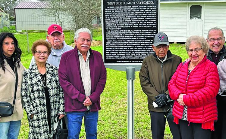 Top: The group picture with marker includes former students and children of students.