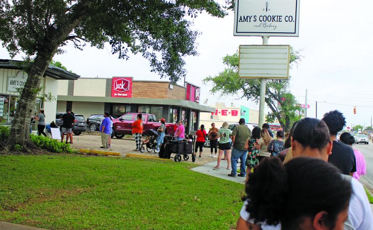 Sentinel Photo/Jessica Shepard The line for Amy's Cookie Co. and Bakery's grand opening stretched down the block on May 2. The bakery is located at 2808 7th St. in Bay City.