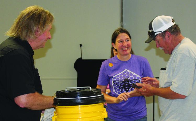 Sentinel Photo/Jessica Shepard Bee Love TX owner Cheryl Wilson, center, discusses various types of equipment needed for apiaries and beekeeping after her "Beekeeping 101 workshop" last week. Wilson partnered with the Matagorda County Texas A&M AgriLife Extension Office to host the event April 30.