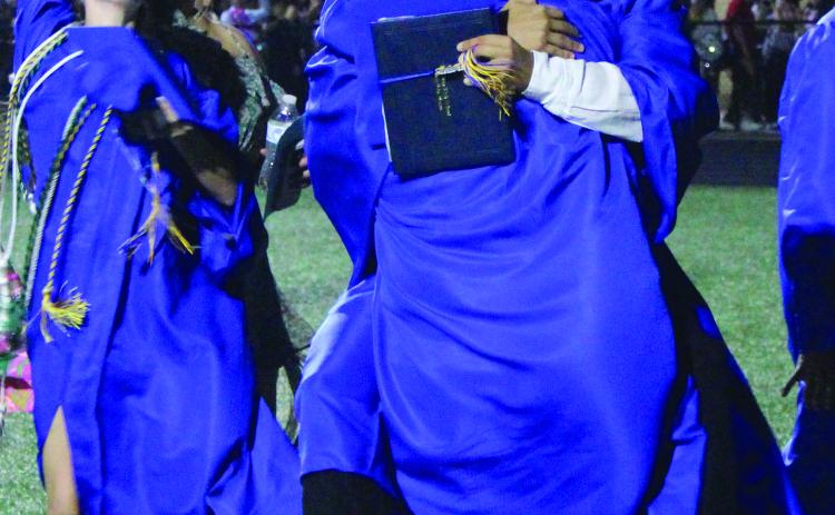 Sentinel Photo/Jessica Shepard Bay City High School's 216 graduating seniors shared their excitement with each other in various easy form hugs to striking energetic poses May 24.