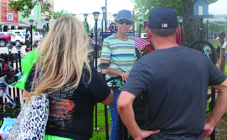Sentinel Photo/Jessica Shepard Matagorda County Trade Days brought plenty of foot traffic downtown on Saturday, April 27. While there were a few new vendors, many of the returning ones braved gusting winds, like this yard art seller discussed customizing options with several customers.