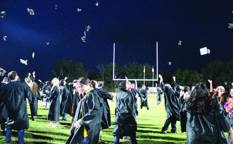 Sentinel Photo/Jessica Shepard Van Vleck graduates hustled to the south end of the football field to toss their caps to celebrate their commencement Thursday, May 23.