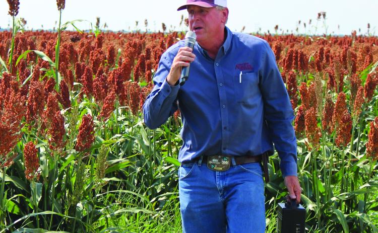 Sentinel Photo/Jessica Shepard Matagorda County Agriculture and Natural Resources Extension Agent Greg Baker identified several crop rows as sorghum grain trial crops near FM 521 to “Matagorda County Row Crop Tour” attendees last Thursday. Baker also took the group to corn and cotton crops in the El Maton area.