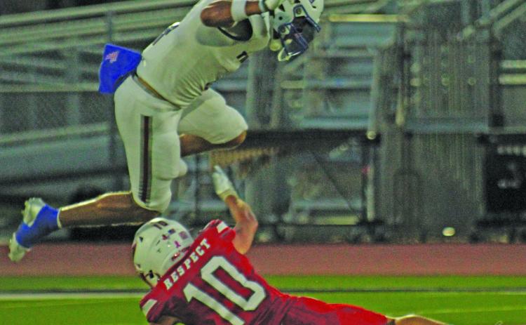 Photo by Anna Hernandez Tidehaven’s Boogie Galvan (4) hurtles over Palacios defender Noah West (10).