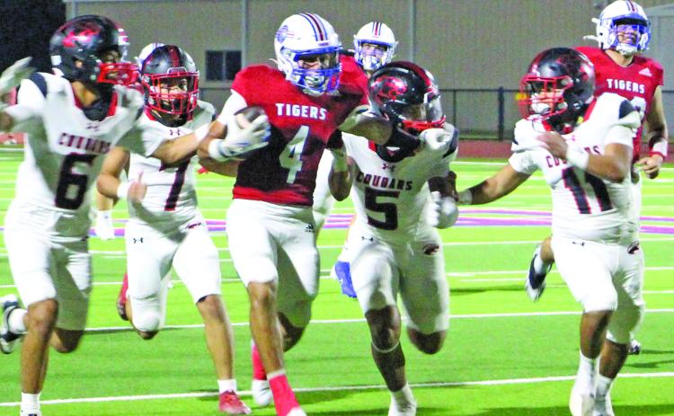Sentinel Photo/Jessica Shepard Tiger running back Boogie Galvan (4) tries to shake several Brazos defenders.