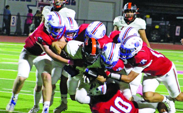 Sentinel Photo/Jessica Shepard Above left, Tidehaven defenders converge on Van Vleeck star running back Corey Austin.