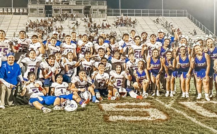Photo/Lauren Russell Tidehaven players, cheerleaders, mascot and coaching staff celebrate the Tigers 3rd straight district championhip after defeating East Bernard Friday night.