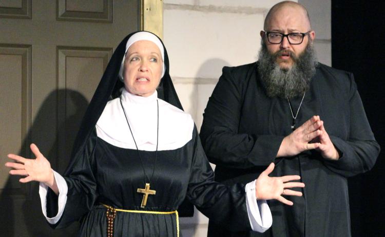 Sentinel Photo/Jessica Shepard Mother Superior (Stacey Steiner), left, and “Father” Paul (Clay Breeden), work out their plan to discover the secret reports a newly appointed nun will send to Rome in CAST’s “Drinking Habits” press night Thursday, March 6.
