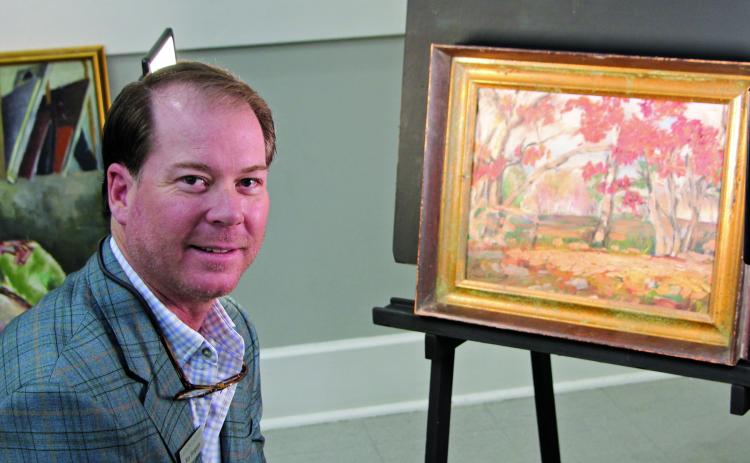 Sentinel Photo/Mike Reddell Houston art appraiser Ray Simpson with one of 45 known or suspected Forrest Bess paintings brought in by several Matagorda County residents last week.