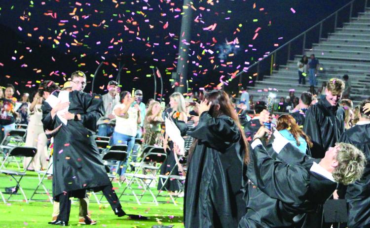 Sentinel Photo/Jessica Shepard Van Vleck graduates tossed their caps to celebrate their commencement, but one graduate had a more enthusiastic sendoff to high school Thursday, May 22.