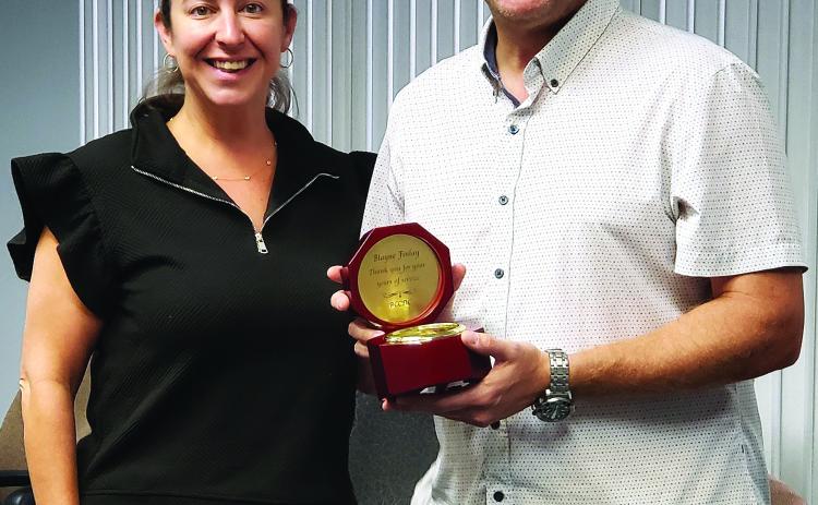 Sentinel photo/Jessica Shepard Bay City Community Development Corporation (BCCDC) recognized former board member Blayne Finlay, right, for his commitment and service while on the board during their monthly meeting Monday, June 30. BCCDC Executive Director Jessica Russell, left, gifted Finlay with a clock on behalf of the board.