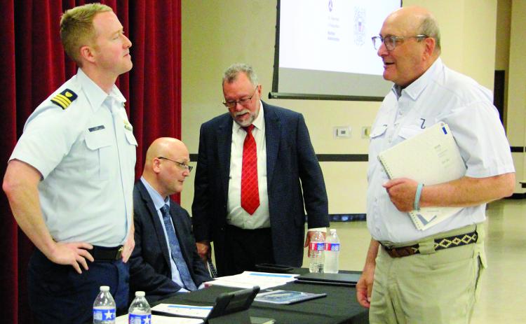 Sentinel Photos/Jessica Shepard At left, US Coast Guard Commander Jake Lobb and Maritime Administration Transportation Industry Analyst Brian Barton led the comment session on the ST LNG deepwater port project last week. Local commenters included Port of Bay City Authority Chairman George Harrison, front right, and Matagorda County Economic Development Executive Director Mike Ferdinand, back right.