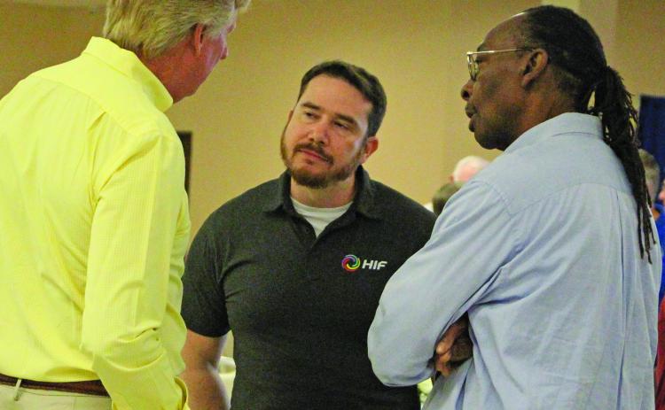 Sentinel Photo/Jessica Shepard HIF-USA Community Affairs and Permitting Manager James Outtrim, center, talks with Nate McDonald, left, and BCISD Trustee Kenneth Eaton during HIF's town hall luncheon Thursday, Sept. 18.