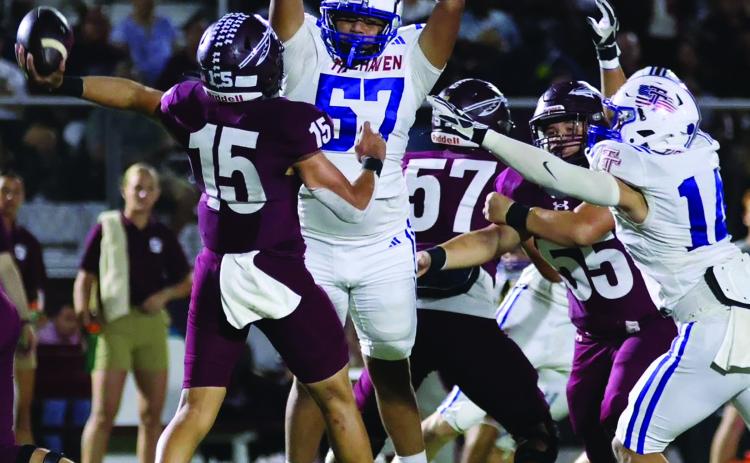 LeDarion Stone/Live in the Moment Photography Tidehaven defenders Jayden Torres (57) and Hayden McCarver make life uncomfortable for the Ganado quarterback.