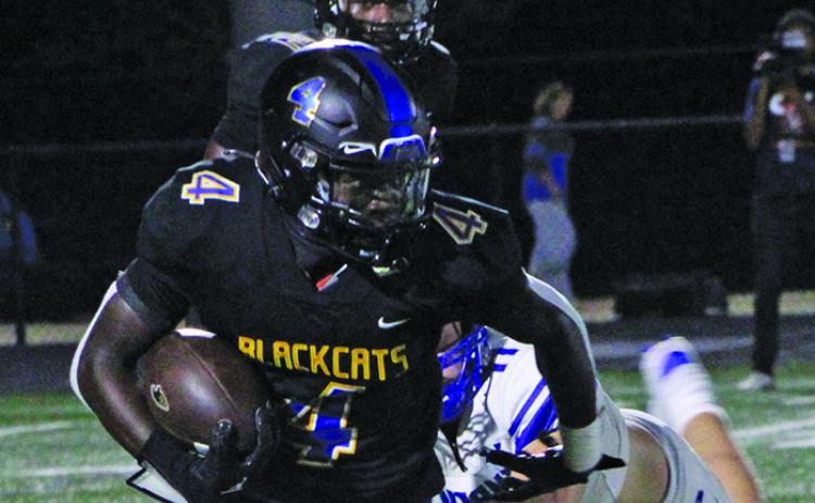 Sentinel Photo/Mike Reddell Bay City junior running back Aiden Williams (4) frees himself from a La Vernia defender to pick up yards.
