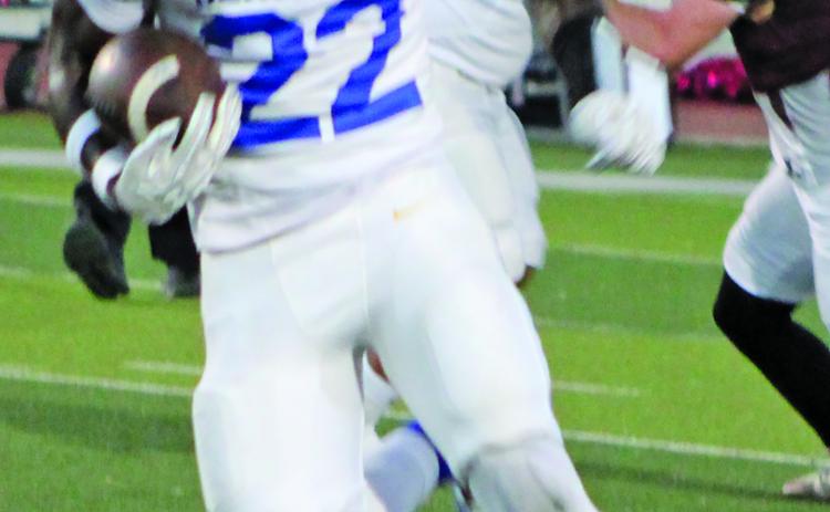 Sentinel Photo/Mike Reddell Bay City back James Copeland (22) picks up yards and a block from junior center Koen Nunez (61) from en route to a game-high 245 yards rushing - and two touchdowns - against Floresville Friday.